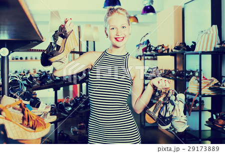 Woman standing in boutique and having many shoes 29173889