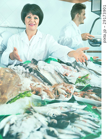 Two sellers posing near display with frozen fish 29173901