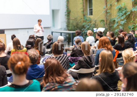 Woman giving presentation in lecture hall at 29182740