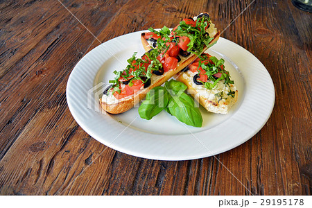 Italian tomato bruschetta with olives on wooden Italian tomato bruschetta with olives on wooden 29195178