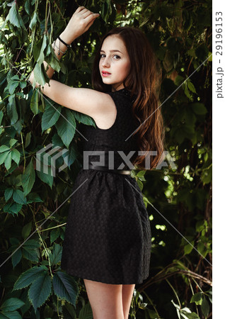Beautiful young girl in black dress with long hair 29196153
