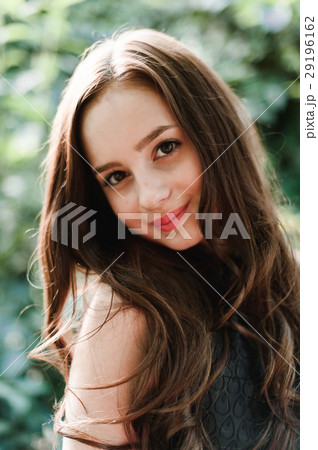 Beautiful young girl in black dress with long hair 29196162