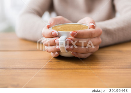 Close-up of woman with cup of coffee in cafe Close-up of woman with cup of coffee in cafe 29196448