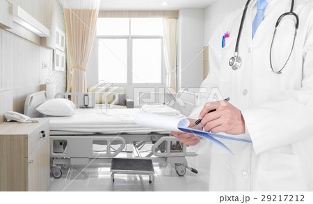 Doctor writing a medical prescription in hospital  29217212