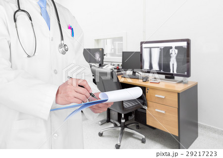 Doctor writing a medical prescription  29217223