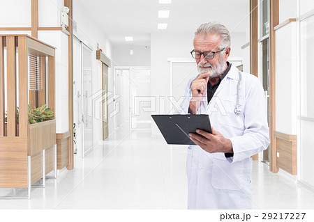 Senior doctor was examine a medical record  29217227