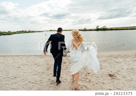 Bride and groom walking at the river 29223375