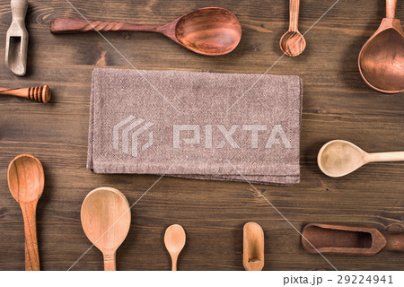 Different wooden spoons around napkins 29224941