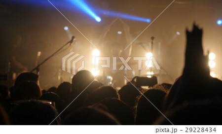 Fans waving their hands at rock concert in night 29228434