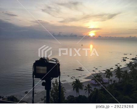 camera take sunrise picture over sea and beach  29229268