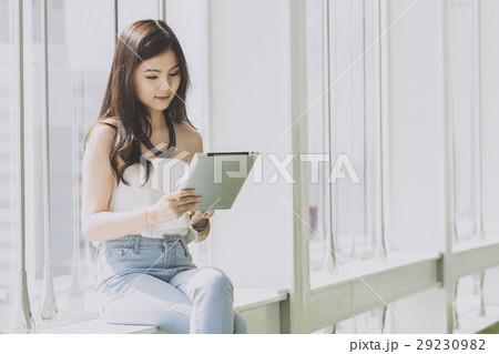 Young business woman looking on the tablet. Young business woman looking on the tablet. 29230982