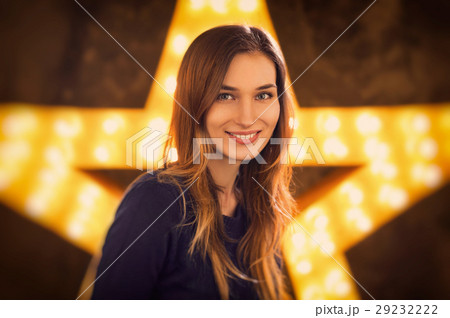 Woman portrait in studio with a big vintage star with a light on 29232222