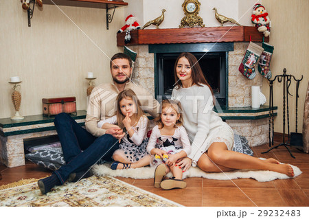 Extended Family Relaxing Together at the fireplace 29232483