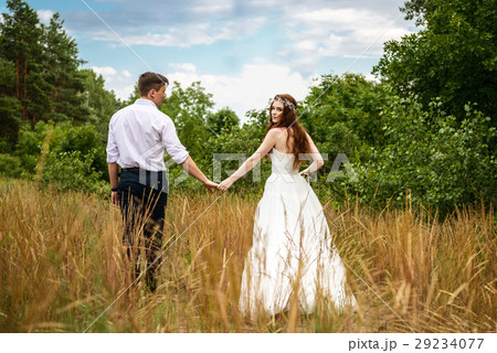 young couple in the ears of wheat in forest 29234077