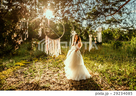 young redheaded girl smiling and hold dreamcatcher young redheaded girl smiling and hold dreamcatcher 29234085