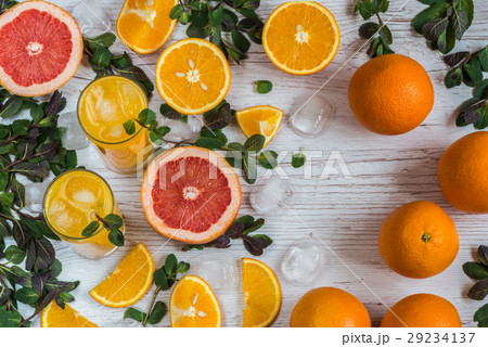 orange juice with ice in glasses near citrus and orange juice with ice in glasses near citrus and 29234137