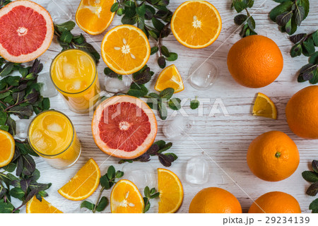 orange juice with ice in glasses near citrus and orange juice with ice in glasses near citrus and 29234139