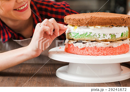 Woman cooking a homemade biscuit cake for selling. Woman cooking a homemade biscuit cake for selling. 29241672