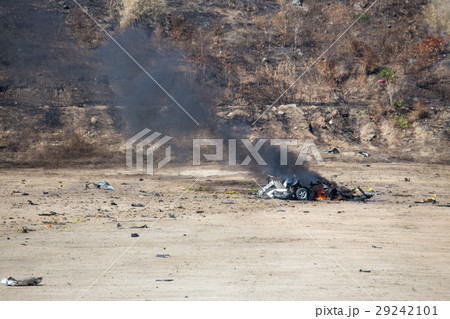 fire and car part blown away from car bomb 29242101