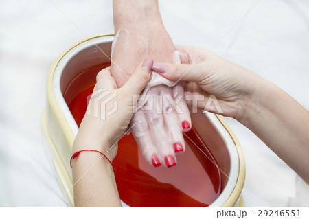 Process paraffin treatment of female hands in beau Process paraffin treatment of female hands in beau 29246551