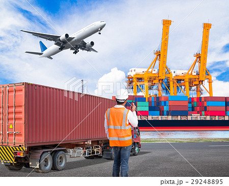 Dock worker talking on radio at ship port 29248895
