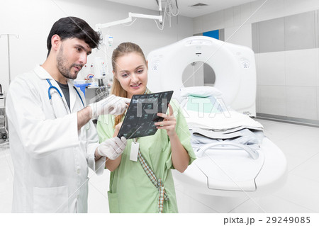 Doctor with patient in CT scan room examining   29249085