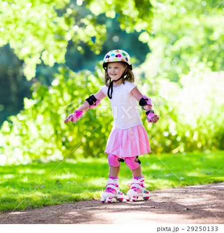 Little girl with roller skate shoes in a park Little girl with roller skate shoes in a park 29250133