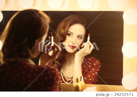 beautiful young woman holding her lipstick 29252571