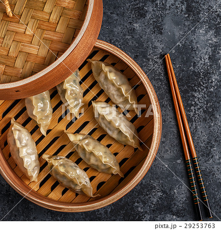 Fresh dumplings on a dark stone background. 29253763