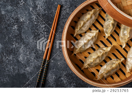 Fresh dumplings on a dark stone background. 29253765