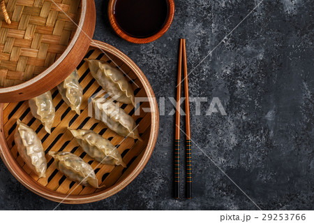 Fresh dumplings on a dark stone background. 29253766