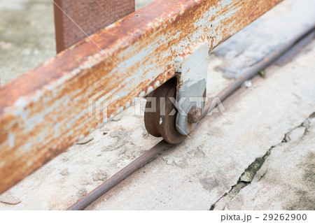 Rusty wheel of the modern fence in urban house. 29262900