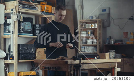 The tall man in the black turtleneck working with 29263109