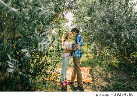 teenage couple kissing in park 29264566