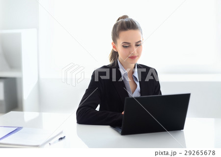 Portrait of beautiful business woman with laptop in the office Portrait of beautiful business woman with laptop in the office 29265678