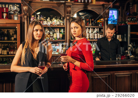 Two attractive young women meeting up in a pub for Two attractive young women meeting up in a pub for 29266020