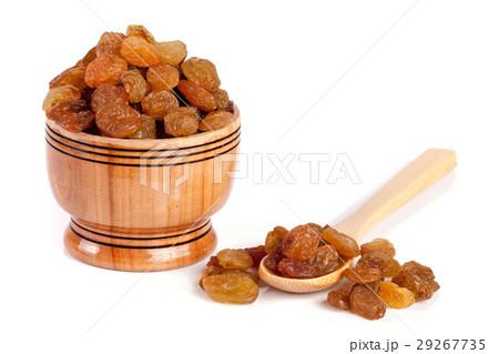 raisins in a wooden bowl with spoon isolated on raisins in a wooden bowl with spoon isolated on 29267735