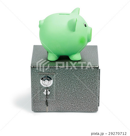 Green ceramic piggy bank standing on a safe Green ceramic piggy bank standing on a safe 29270712