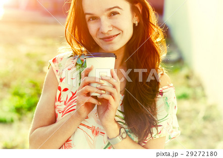 smiling pretty girl walking with morning coffee 29272180