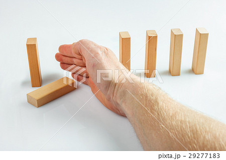 Hand stopping dominoes falling Hand stopping dominoes falling 29277183