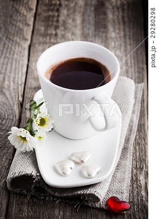 Cup of coffee served on a wooden surface 29280298