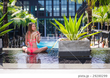 An attractive young woman doing yoga beside the 29280299