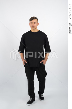 muscular man wearing black clothes and sneakers 29282407