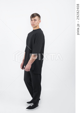 muscular man wearing black clothes and sneakers 29282408