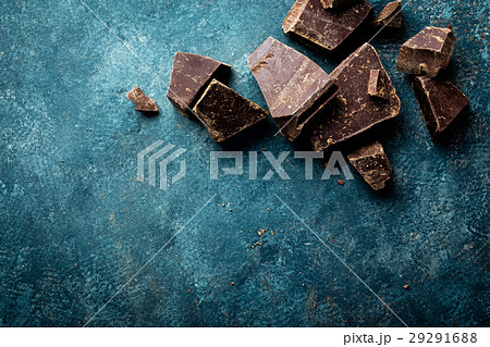 Dark chocolate pieces crushed on a dark background Dark chocolate pieces crushed on a dark background 29291688