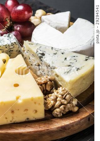 Cheese plate with fruits and nuts on a wooden   29294541