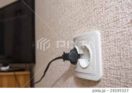 Male hand puts plug in the socket 29295327