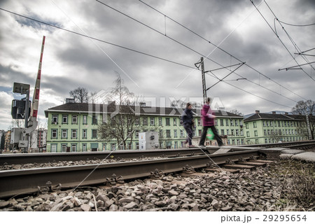Pedestrians crossing rails. Open boom barrier 29295654