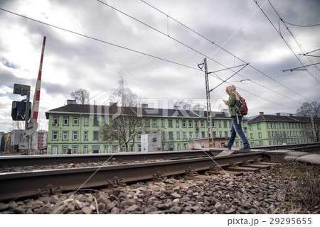Man crossing rails. Open boom barrier 29295655