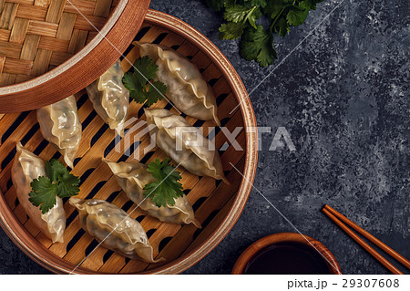 Fresh dumplings on a dark stone background. 29307608